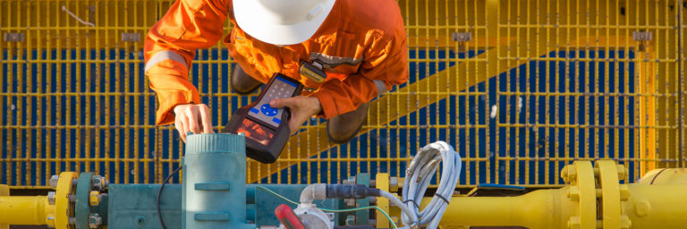 Technician inspecting flow meter